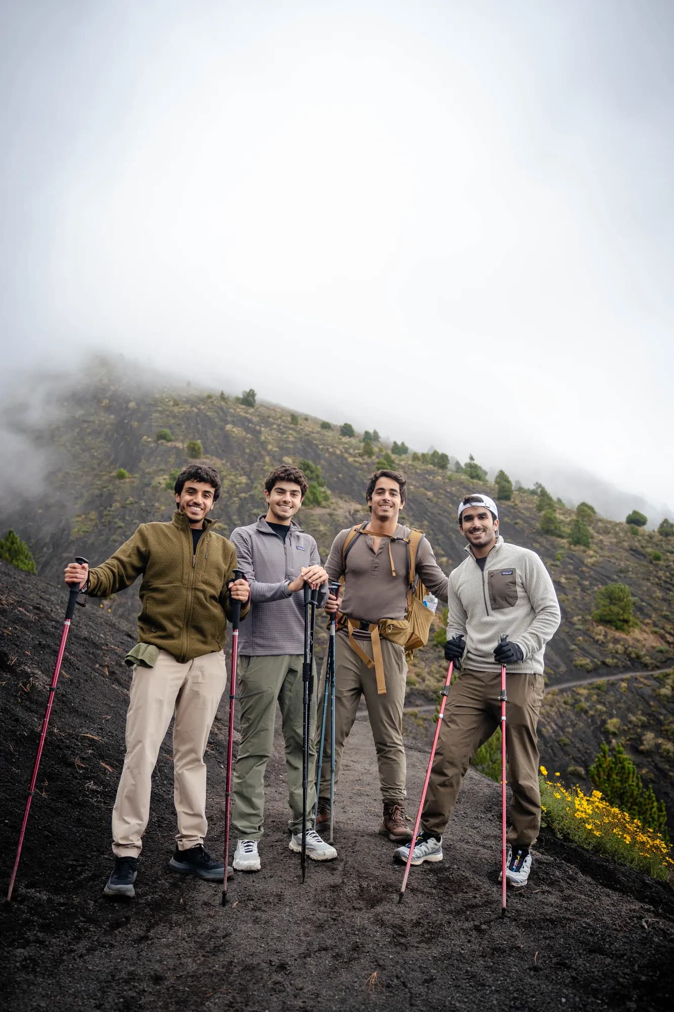 A group resting in the fog high on the mountain