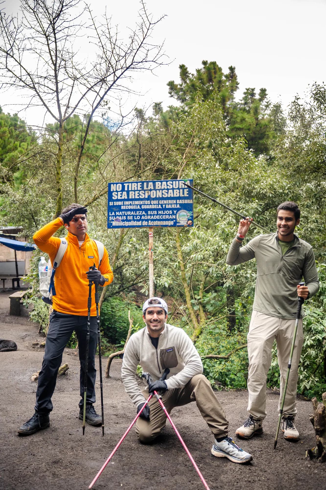 A group posing by a trail sign at the start of the hike