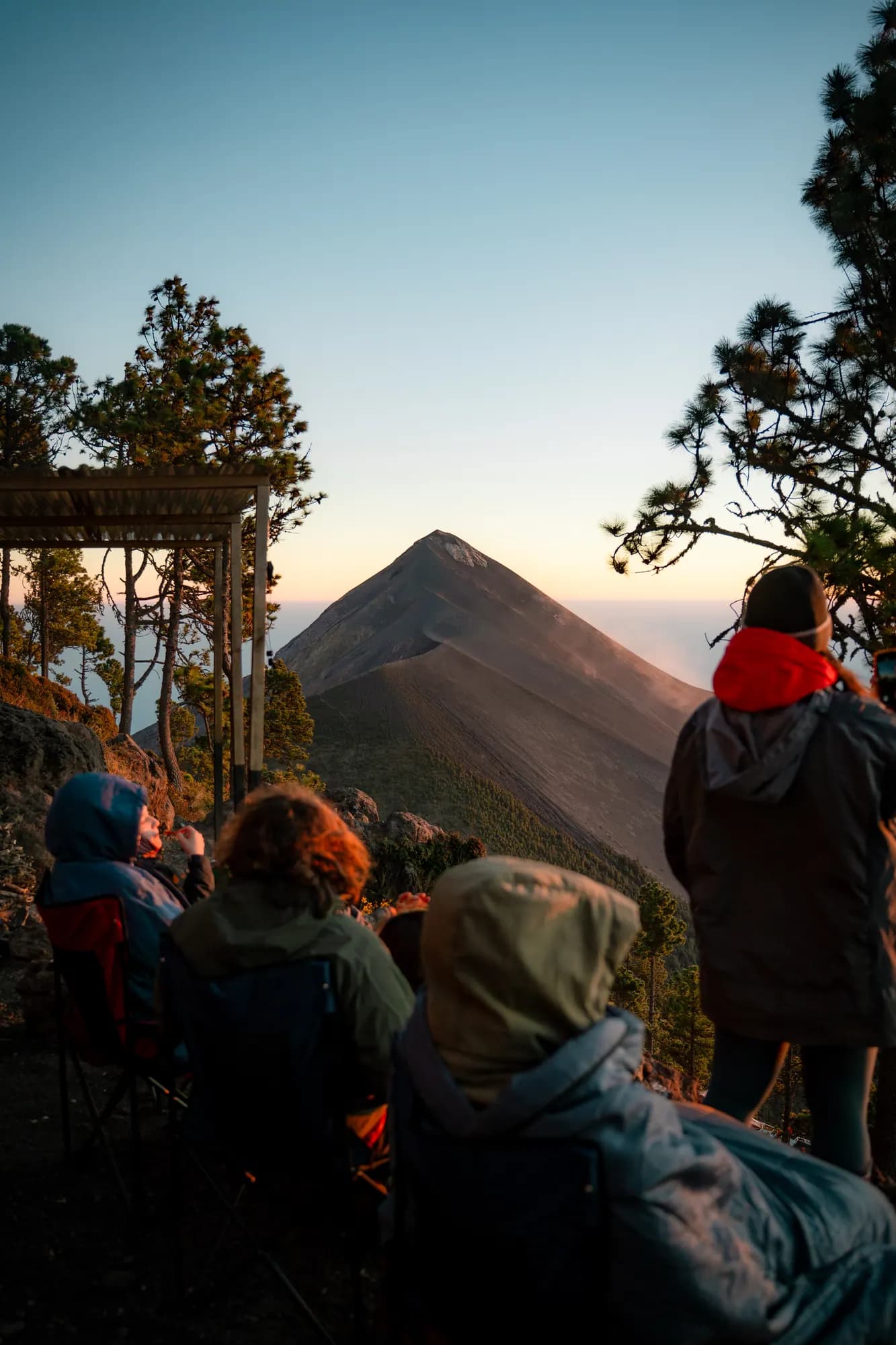 The camp at dusk with Volcán de Fuego across the valley