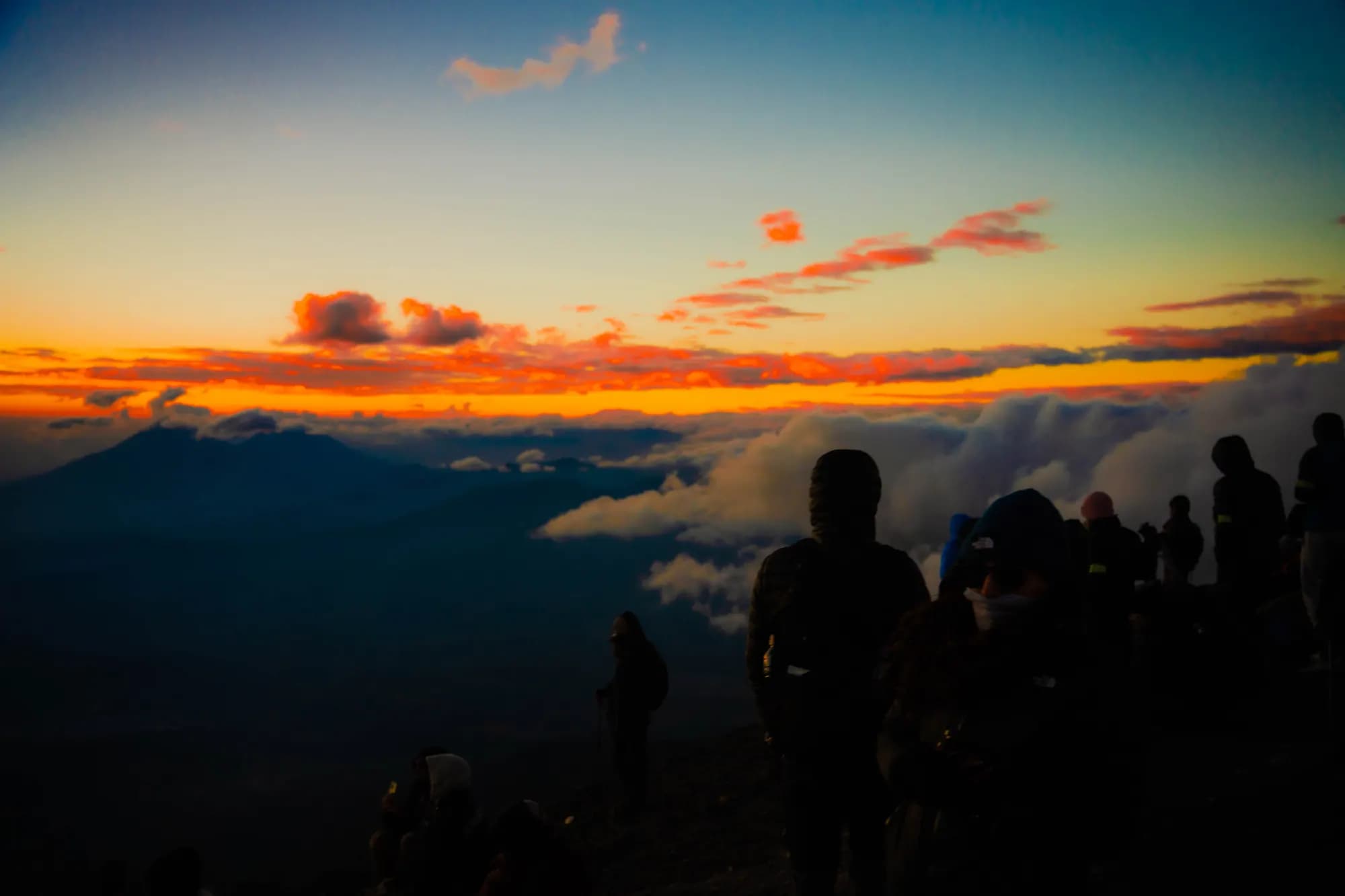 Silhouettes above a sea of clouds