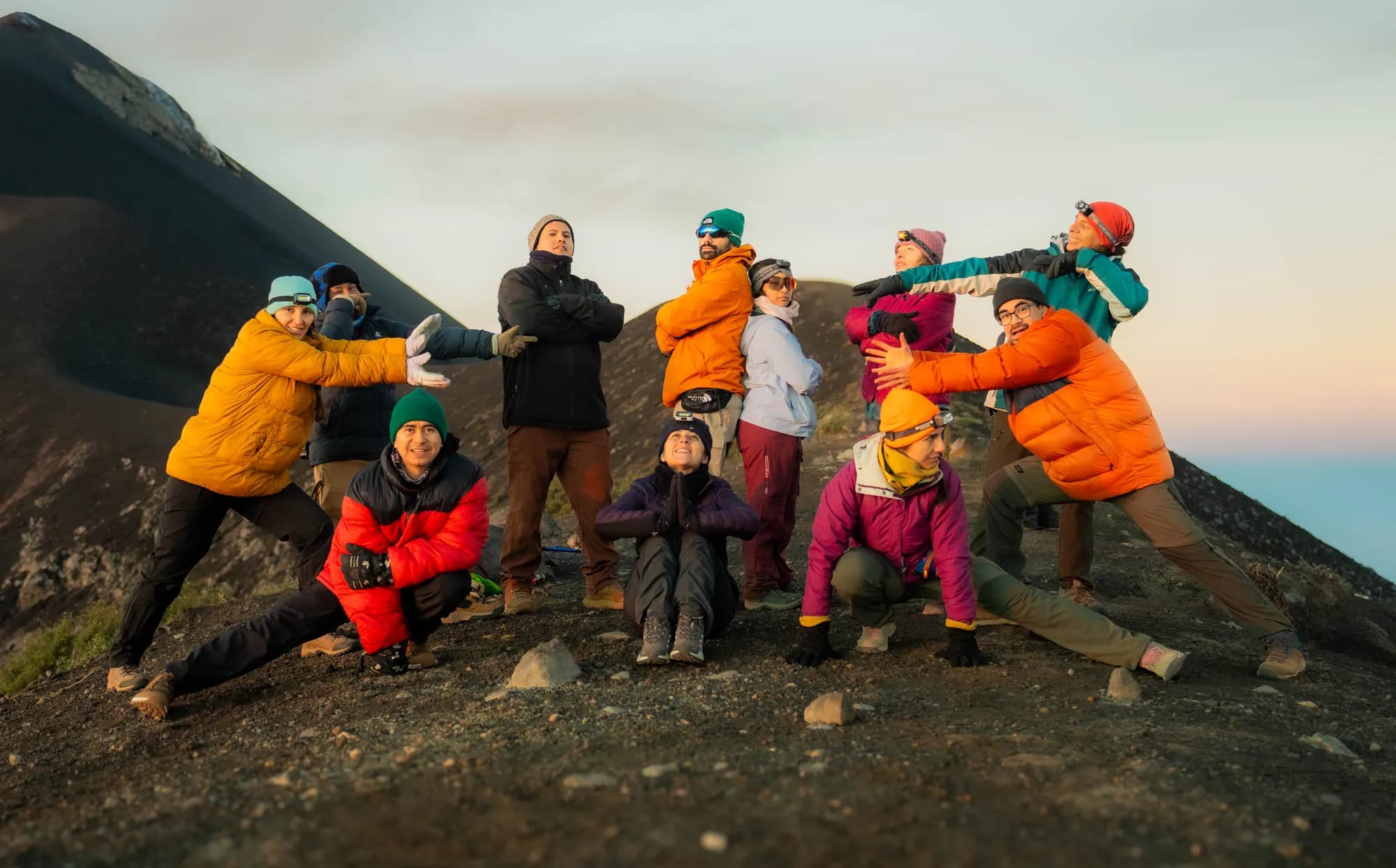 A group in bright jackets celebrating on the ridge